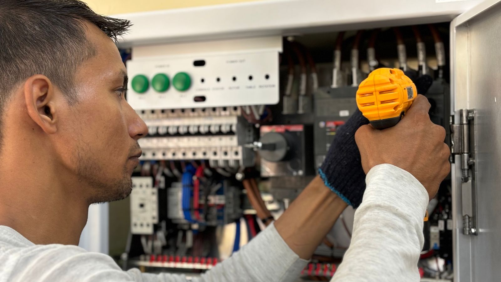 Qualified electrician working on a residential electrical panel